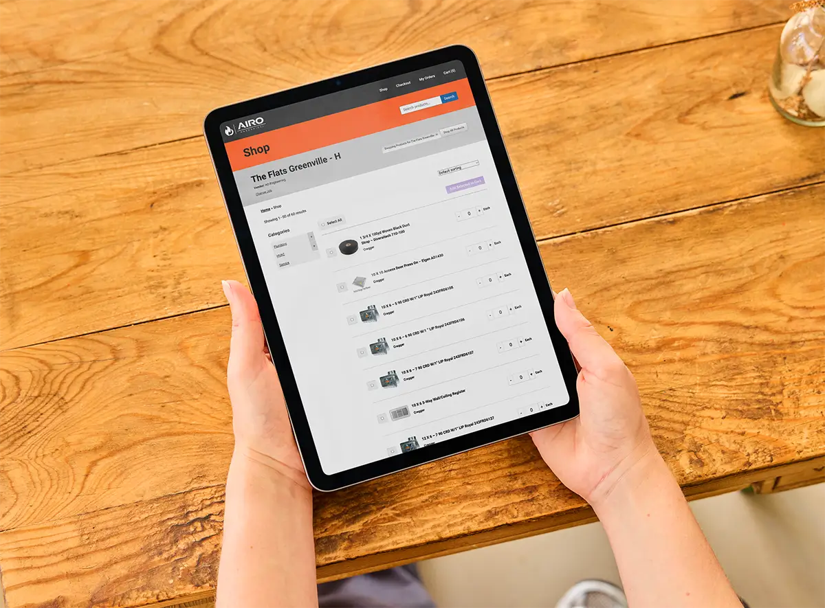 hands holding a tablet with the airo purchasing site on the screen